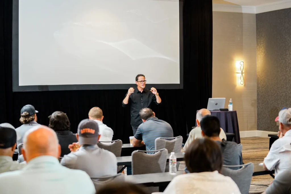 Presenter speaking to a seated conference audience