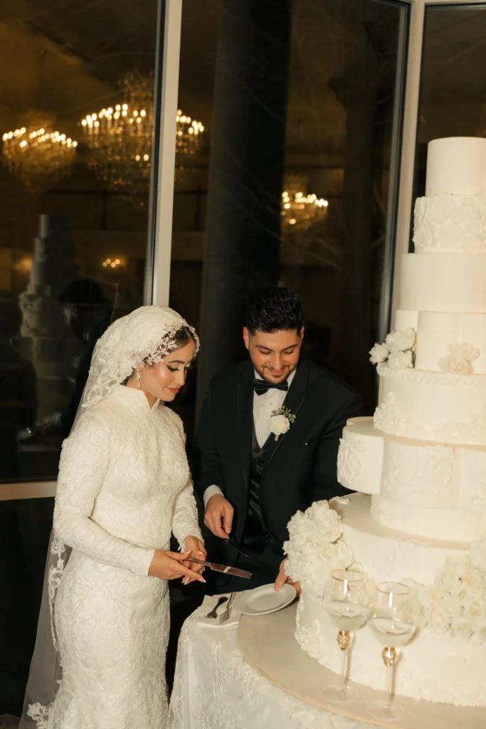 Bride and groom cutting their tiered wedding cake