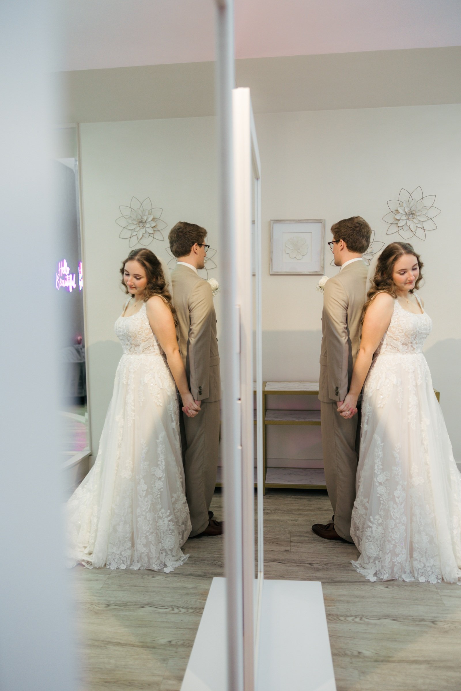 Gabe and Krista holding hands back to back inside Brighton Abbey before their ceremony