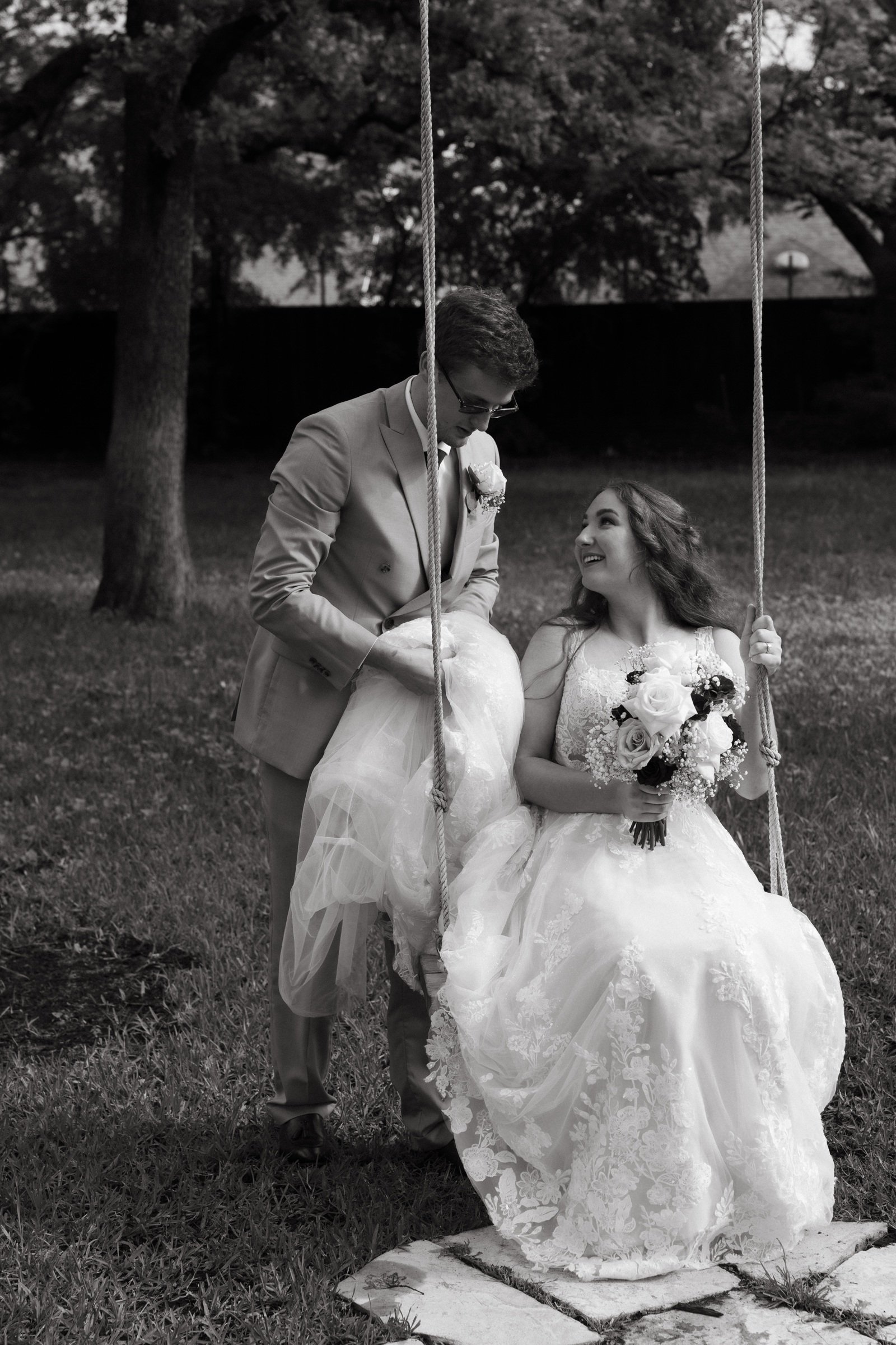 Krista on a garden swing with Gabe beside her at Brighton Abbey